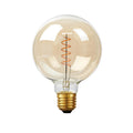 G125 E27 LED filament bulb, amber glass, spiral filament, lit, on a white background