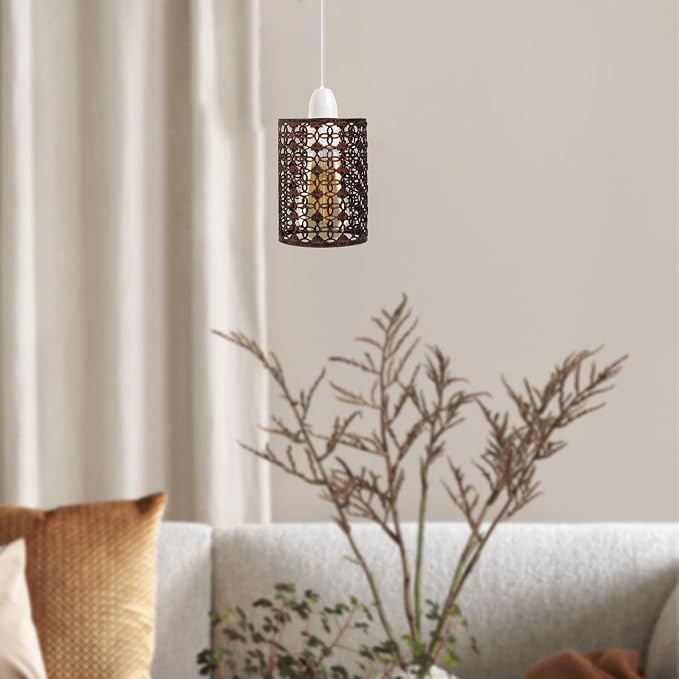A lit metal cage lamp shade hanging in a living room.