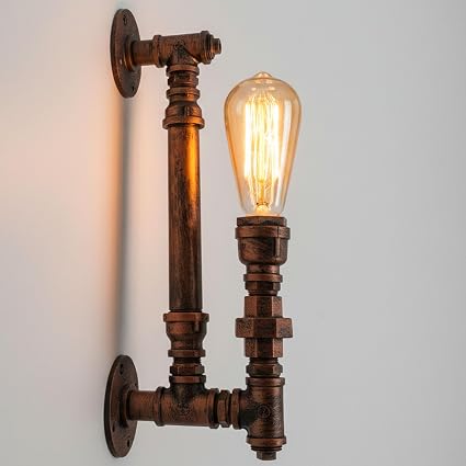 A steampunk wall light with a rusty red industrial pipe design mounted on a wall, featuring one lit bulb.