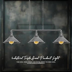 A steampunk ceiling light with three lit bulbs in textured metal shades, shown against a dark background.
