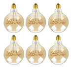 G125 E27 LED filament bulb with Love script filament, amber glass, lit, six bulbs on a white background