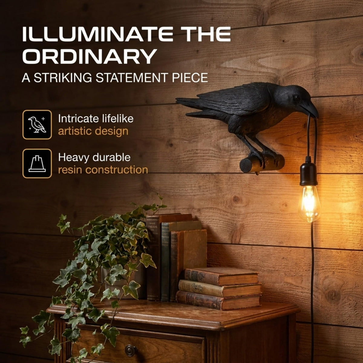 A black raven lamp with a lit bulb is mounted on a wooden wall above a plant and books.