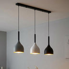 Dining room with pendant lights hanging above a table.