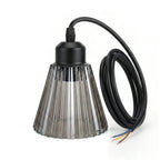 A smoky grey ribbed glass lamp shade with an E27 fitting and black cord, unlit,