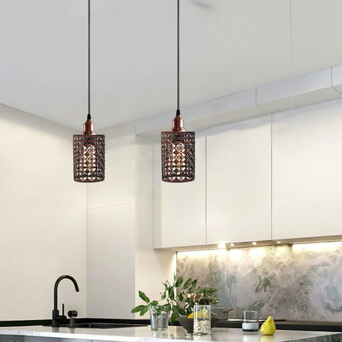 Modern kitchen with pendant lights hanging above a countertop.