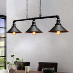 A steampunk ceiling light with three lit bulbs in black conical shades, mounted on a pipe fixture.