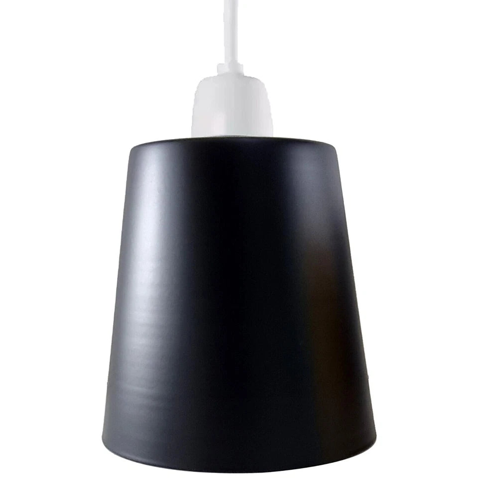 A black metal lamp shade is unlit and shown next to its white packaging