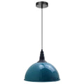 A blue pendant light hangs from a ceiling with a black cord and fitting, unlit, on a white background.