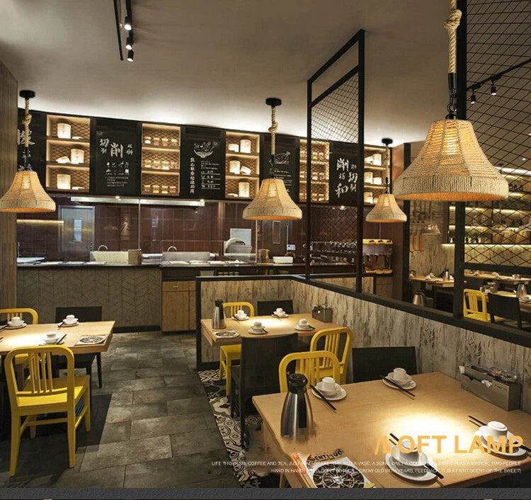 Three lit vintage hemp rope pendant lights hanging in a restaurant setting.